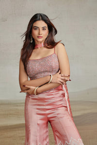 Woman in a peach salwar kameez with a neutral background