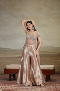 Woman in a glamorous Peach net organza salwar suit with zardosi and zari embroidery