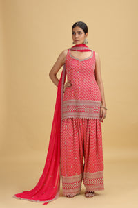 Woman wearing a pink salwar kameez suit with Georgette Dupatta