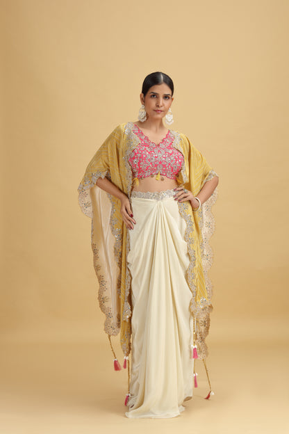 Woman wearing a traditional outfit with a yellow dupatta and pink suit on a beige background