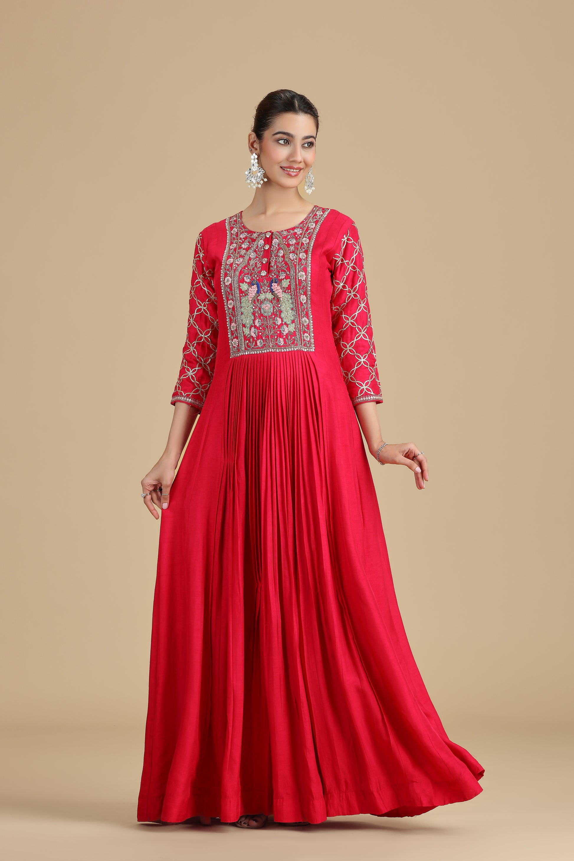 pink raw kurta set with intricate embroidery on a beige background