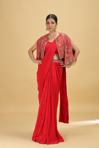 Woman wearing a red crepe saree with a matching silk blouse 