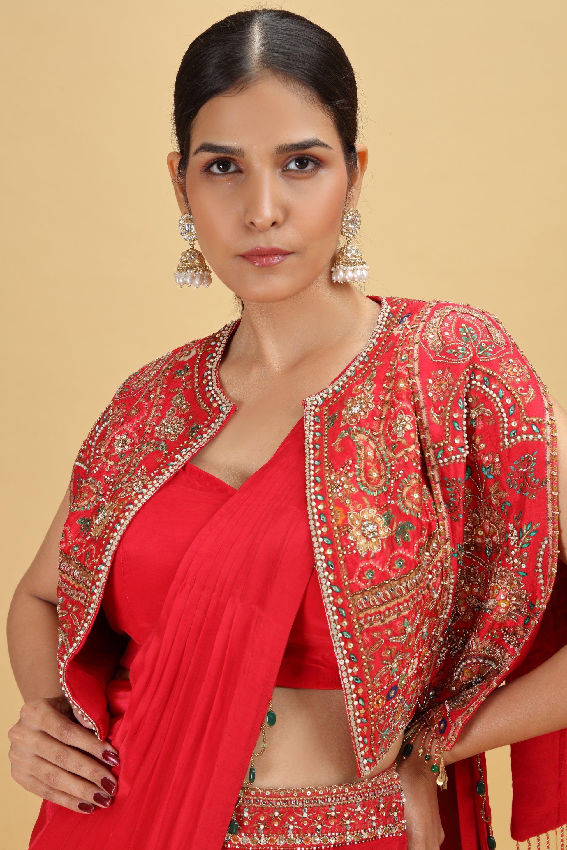 Woman wearing a red saree with dola silk blouse with Moti, Sequins work