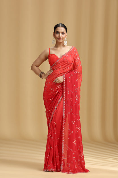 Woman wearing a red saree with a beige background