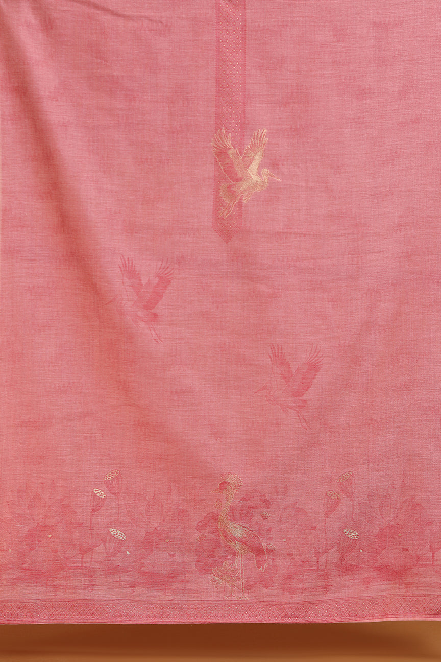 Maroon fabric with embroidered patterns on a wooden surface