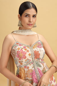 Woman wearing a floral embroidered dress with a beige background
