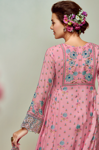 Woman wearing a pink cotton kurta with floral hair accessories against a neutral background