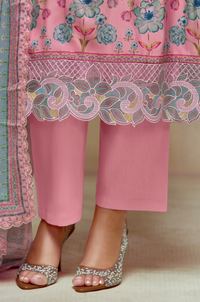 Pink traditional outfit with floral patterns and embellishments on a neutral background