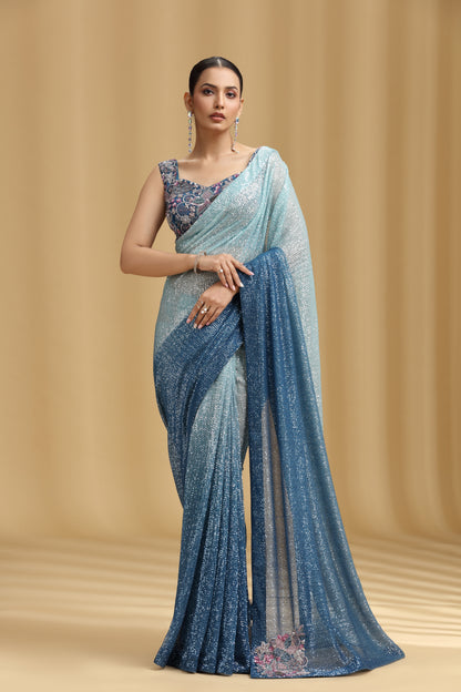 Woman wearing a blue saree with a beige background