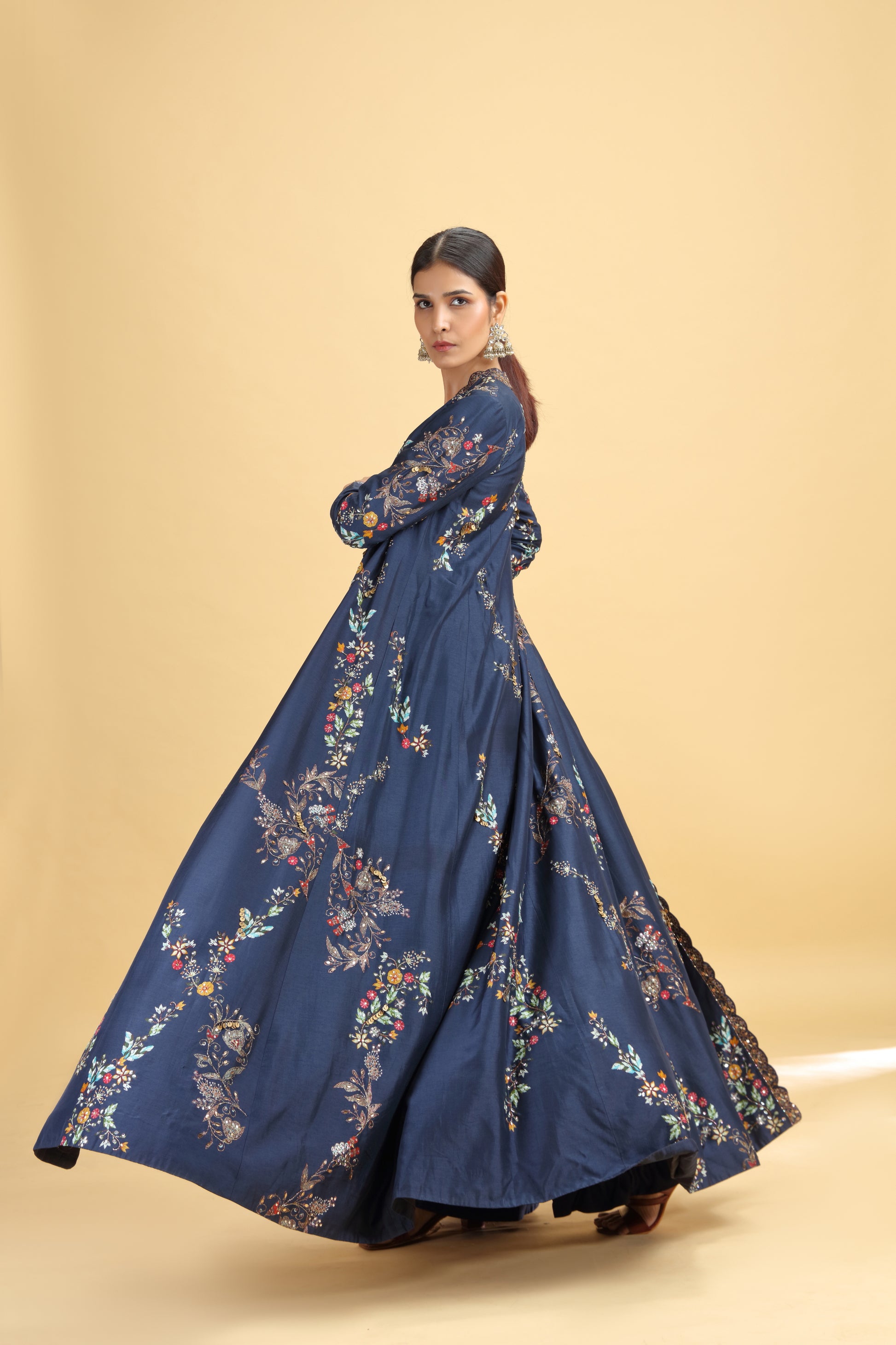 Woman wearing a blue floral dress on a beige background
