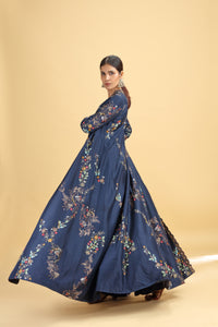 Woman wearing a blue floral dress on a beige background